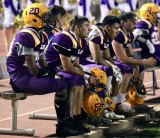 Players watch as their season nears an end in the fourth quarter Friday night against Hanford High School.